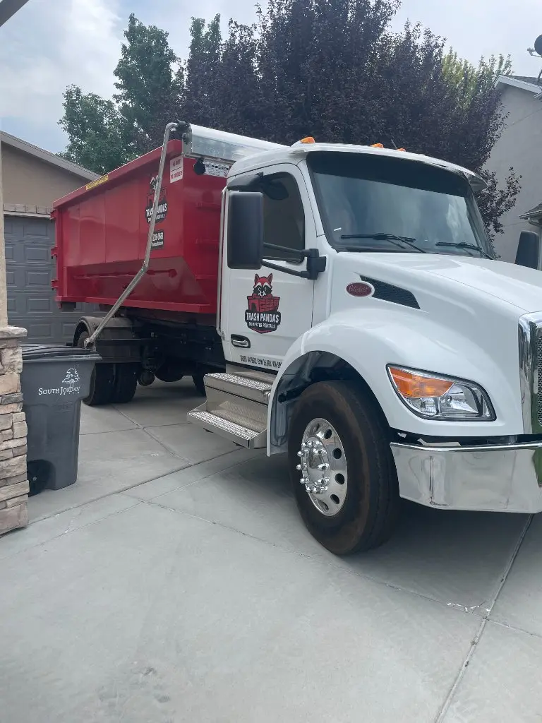 Trash Pandas Utah truck delivering a roll-off dumpster in South Jordan